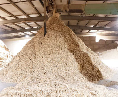 Bulk wood shavings meant for animal bedding, inside the storage facility at Mala Mills, LLC